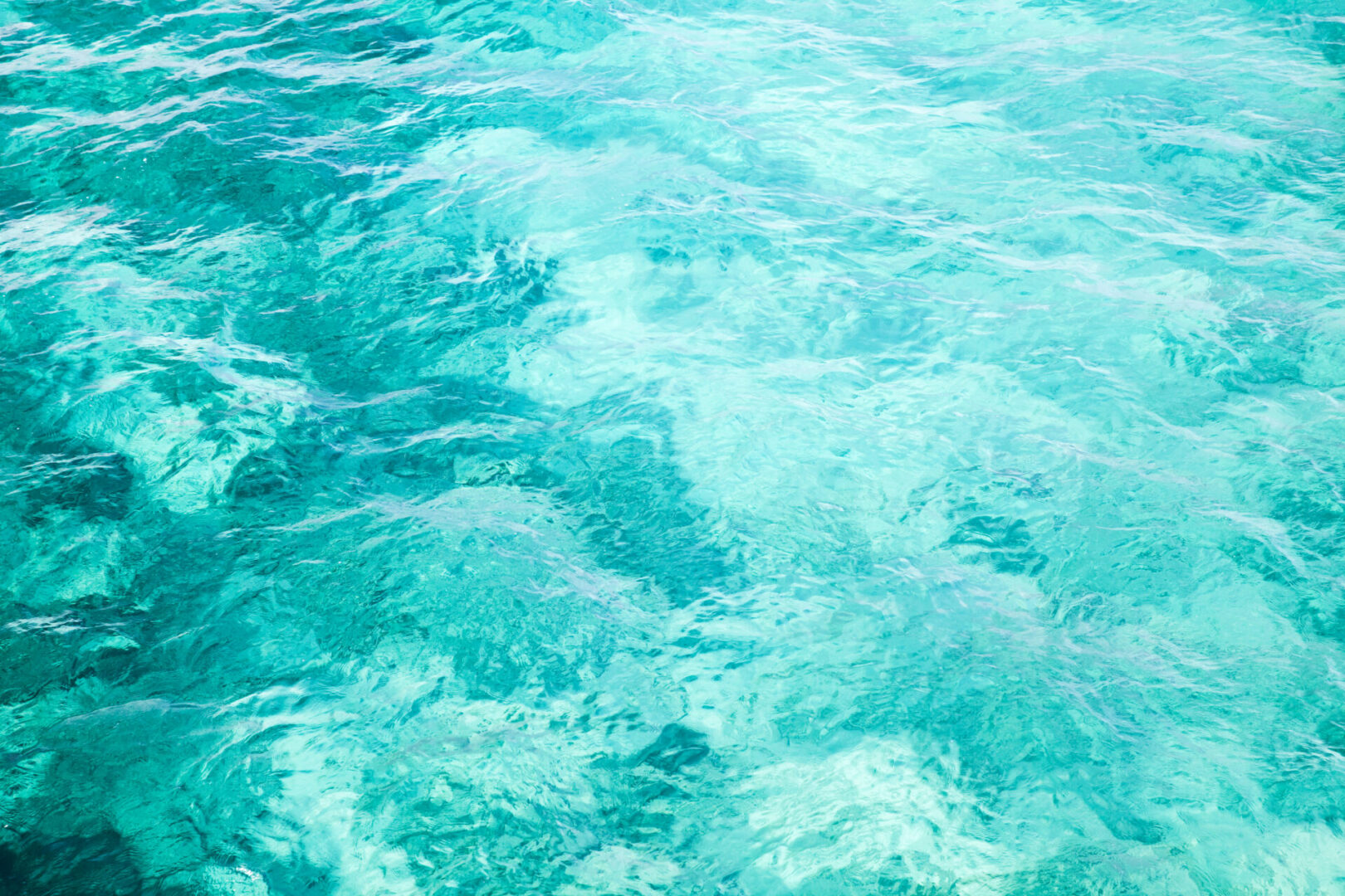 Clear turquoise ocean water with gentle ripples.