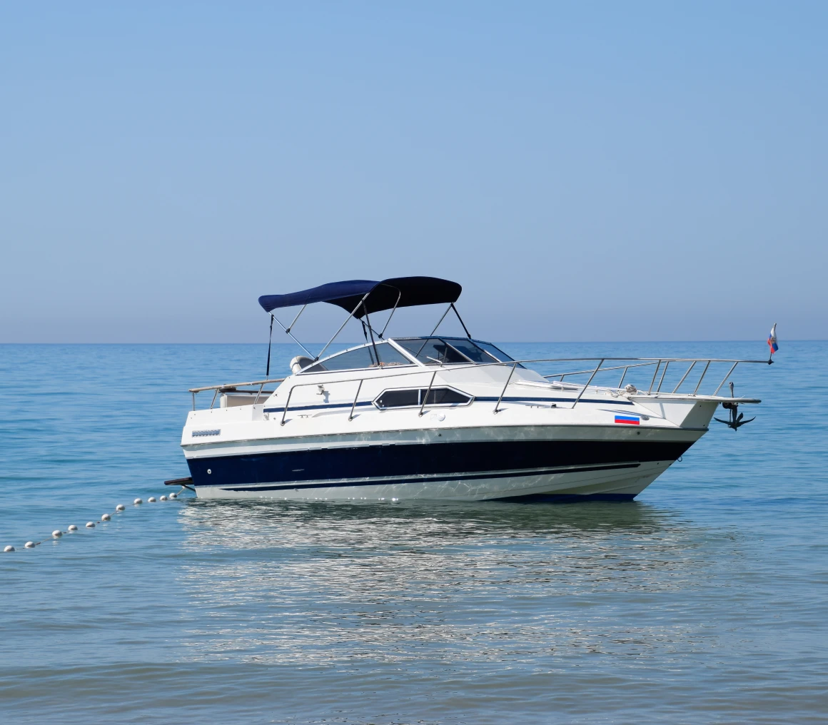 Small yacht with canopy at sea