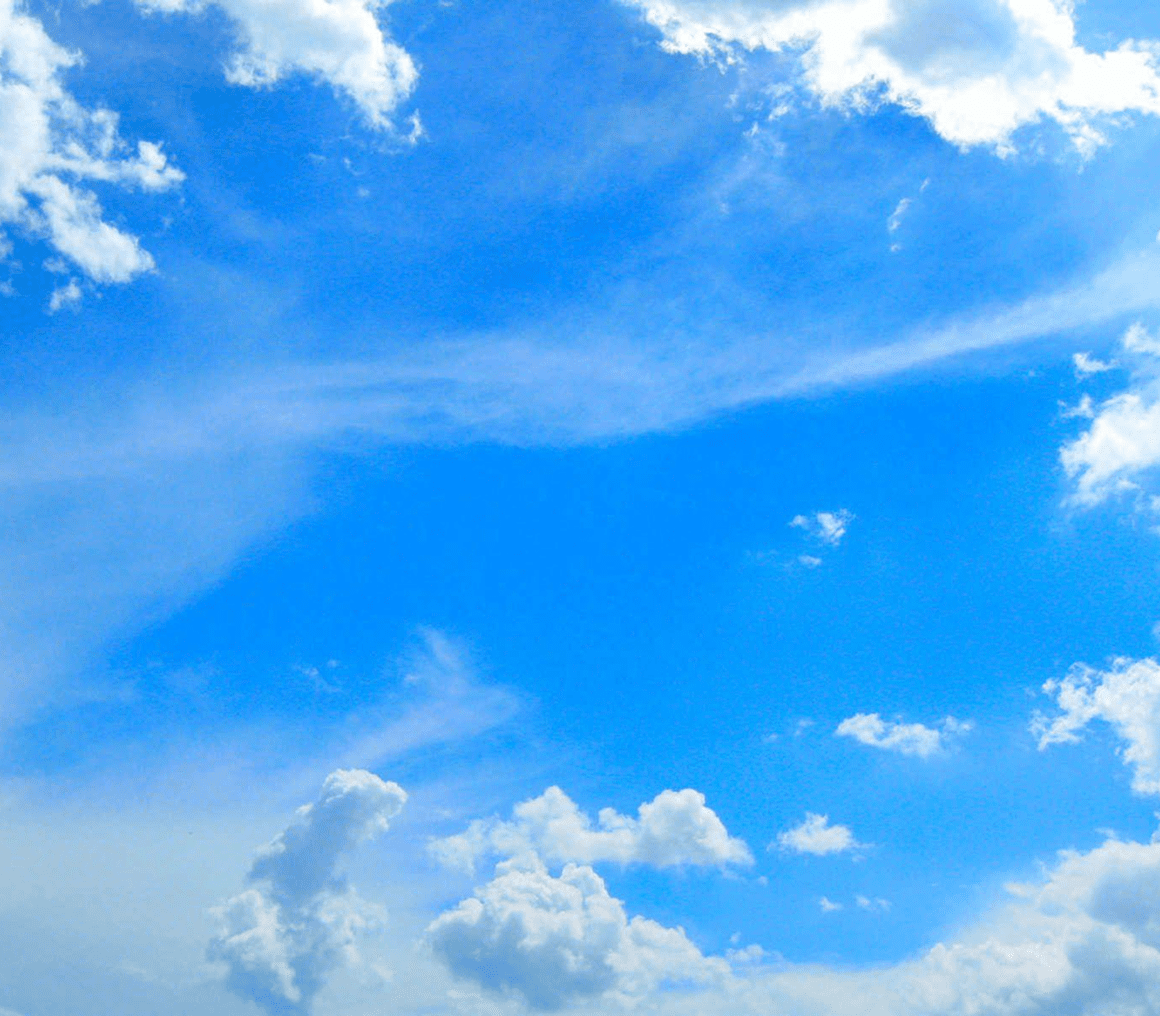Blue sky with fluffy white clouds.