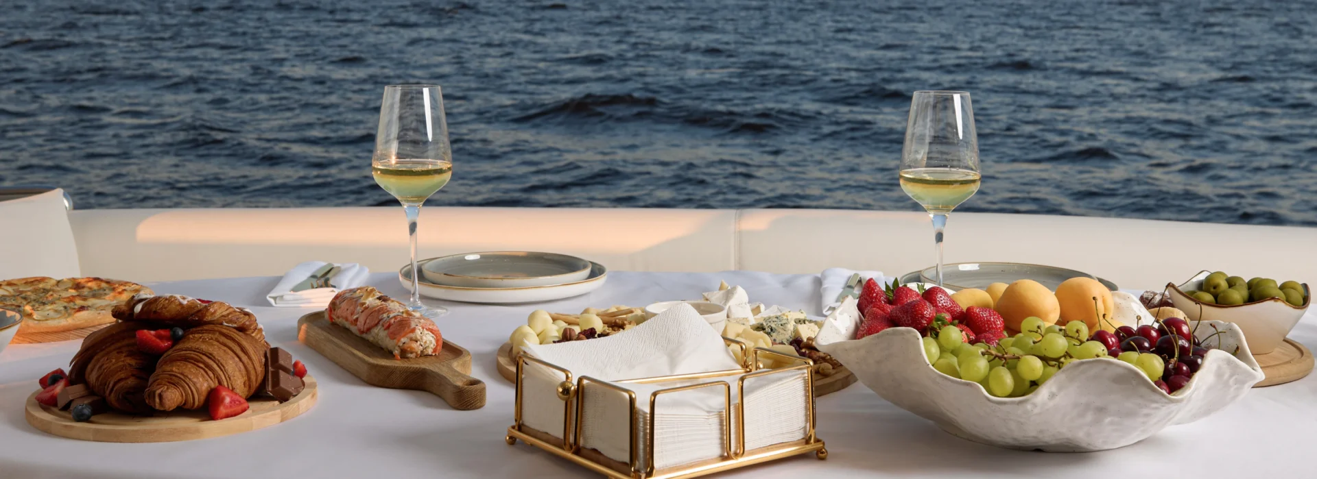 Elegant seaside meal setup with wine